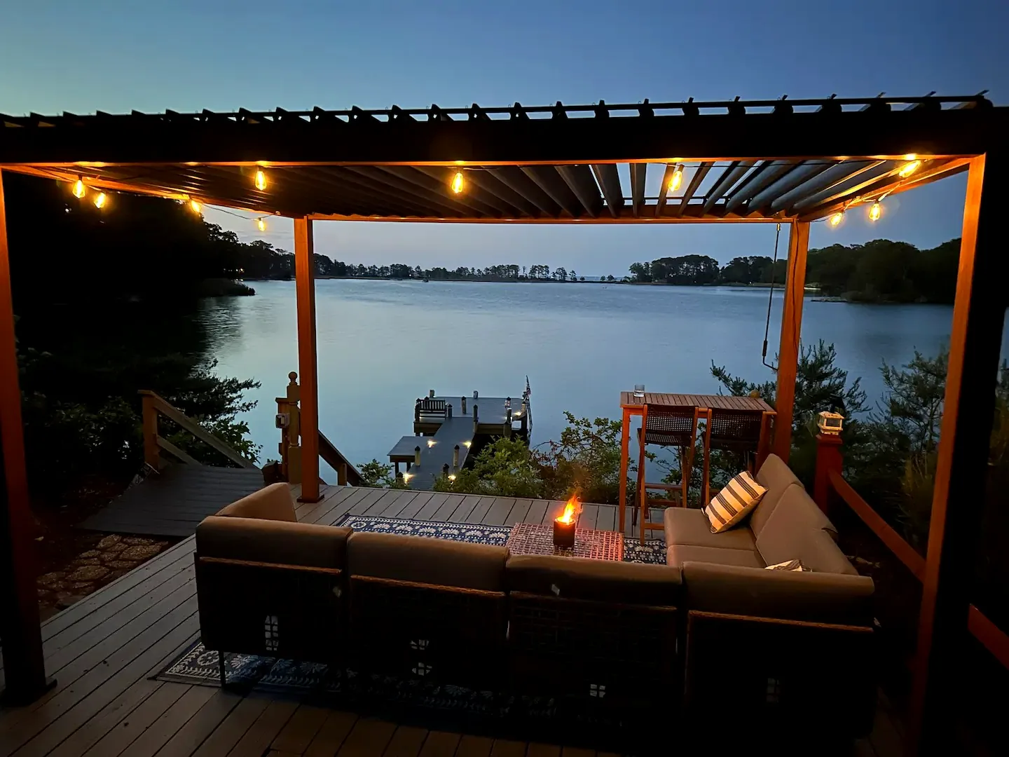 Pergola lounge glowing at blue hour with water views